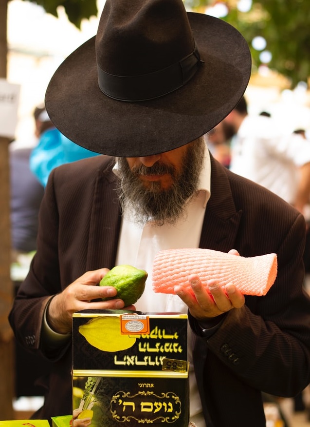 inspecting a citron in mahane yehuda market
